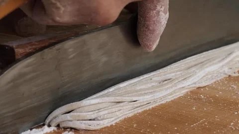 Professional Chef Skillfully Hand-Cutting Fresh Soba Noodles with Traditional Cl Stock Footage 333568665