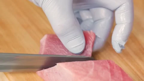 Professional Chef Skillfully Slicing Fresh Bluefin Tuna for Sashimi on Wooden Bo Stock Footage 333499310