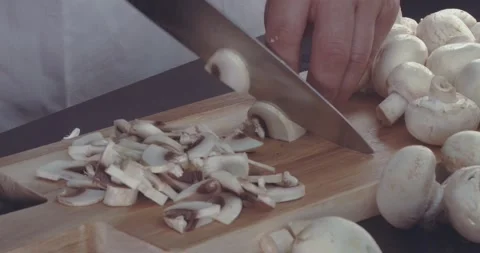 A Professional Chef Slices The Mushrooms Into Thin Slices For A Signature Dish. Stock Footage 143566722