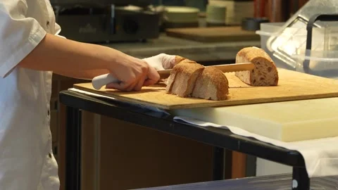 Professional Chef Slicing Fresh Bread in Commercial Kitchen. Chef in white .. Stock-Footage 331213463