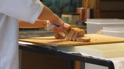 Professional Chef Slicing Fresh Bread in Commercial Kitchen. Chef in white .. Stock Footage 331213535
