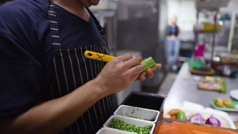 Professional Chef Slicing Fresh Cucumber in a Commercial Kitchen Stock Footage 337281371