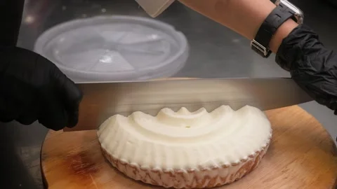 Professional Chef Slicing Fresh Lemon Meringue Tart with Large Kitchen Knife Clo Stock Footage 337751560