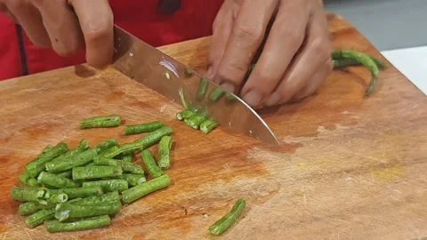 Professional Chef Slicing Fresh Long Beans on Wooden Cutting Board Video stock 327650954