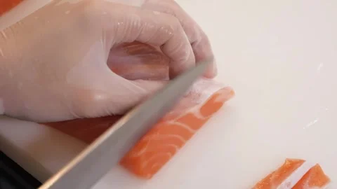 Professional Chef Slicing Fresh Salmon Fillet for Sushi and Sashimi on White Cut Stock Footage 333489495
