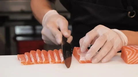 Professional Chef Slicing Fresh Salmon Fillet for Sushi and Sashimi Stock Footage 333600258
