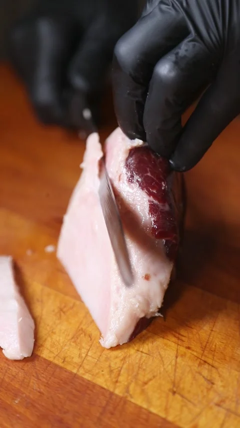Professional chef slicing Iberian ham on a wooden cutting board. Stock Footage 335653552