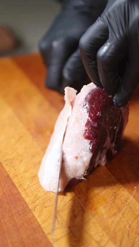 Professional chef slicing Iberian ham on a wooden cutting board. Stock Footage 335653553