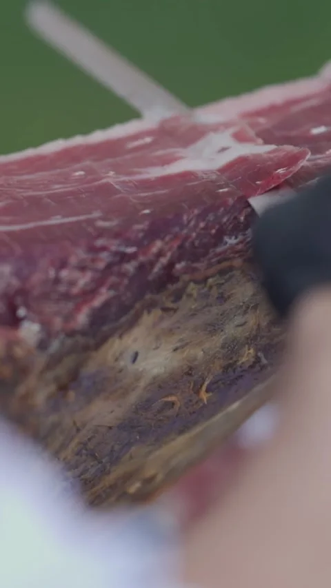 Professional chef slicing jamon iberico with precision Stock Footage 327805984