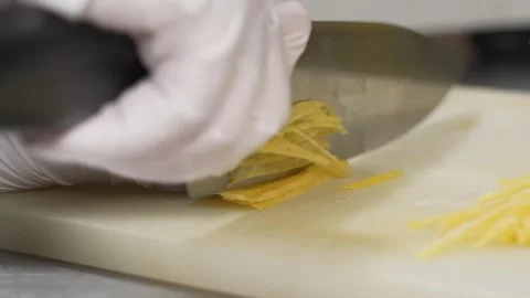 Professional Chef Slicing Lemon Zest into Fine Julienne Strips for Gourmet Desse Stock Footage 337751179