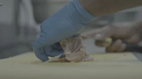 Professional chef slicing raw chicken into small strips Stockbeeldmateriaal 327356689