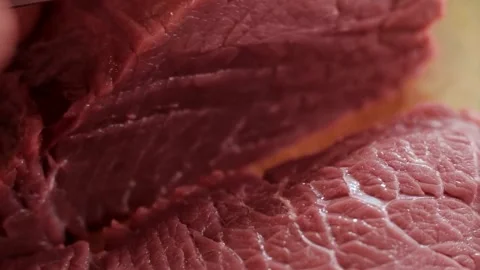 Professional chef slicing raw red beef on wooden board Stock Footage 333833758