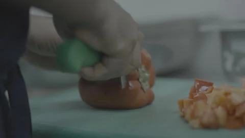 Professional chef slicing a red bell pepper in close-up Stockbeeldmateriaal 327356190
