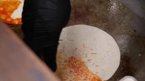 Professional Chef Spreading Birria Sauce on Tortillas on a Flat Top Grill Stock Footage 331635966