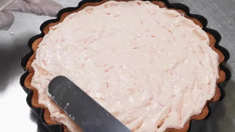 Professional Chef Spreading Strawberry Cream Filling into a Fluted Tart Crust Stock Footage 337751329