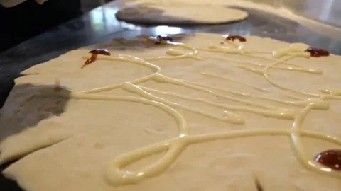 Professional Chef Spreading Tomato Sauce and Cream on Fresh Italian Pizza Dough Stock Footage 337677892
