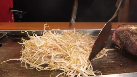 Professional Chef Stir-Frying Fresh Mung Bean Sprouts on Teppanyaki Grill Stock Footage 333520590