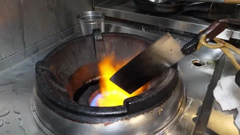 Professional Chef Stir-Frying with Intense Gas Flame on Wok Burner 스톡 동영상 332817401