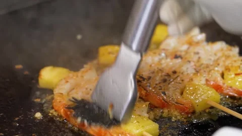 Professional Chef Stir-Frying Shrimp and Pineapple on Commercial Griddle Stock Footage 337440685