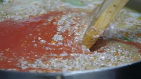 Professional Chef Stirring Authentic Italian Tomato Pizza Sauce with Wooden Spat Stock Footage 337678360