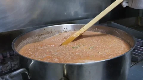 Professional Chef Stirring Fresh Tomato Pizza Sauce in Large Stainless Steel Pot Stock Footage 337678416