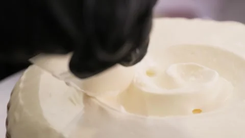 Professional Chef Styling Creamy Cheesecake with Elegant Spatula Swirl Texture Stock Footage 337751474