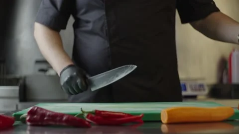 A professional chef takes a stalk of celery and begins to cut it. Stock-Footage 231053592