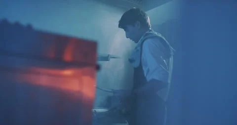 Professional chef taking meat dish off of grill Stock Footage 203556316