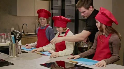 Professional Chef Teaching Children Cooking in Culinary Class Stock Footage 339499387