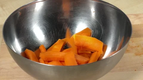 A professional chef throws vegetables into a plate Stockbeeldmateriaal 306803151