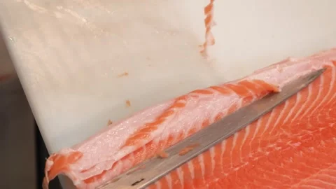 Professional Chef Trimming Salmon Belly Fat from Fresh Fillet on White Cutting B Stock Footage 333489140