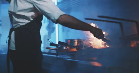 Professional chef using fire grill in professional kitchen Stock Footage 203555933