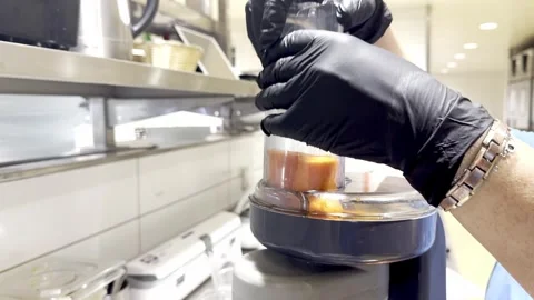 Professional chef using a food processor to grate carrots in a restaurant kitche Video stock 342711958