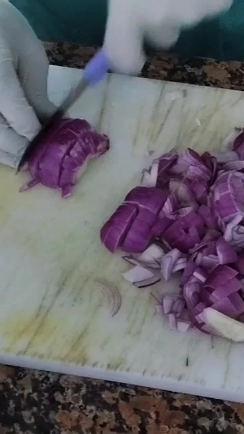 Professional chef in white gloves chopping red onions and tomatoes on Stock Footage 330574136