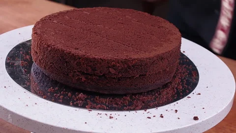 Professional chef's hand is cutting sponge cake. Stock Footage 141585877