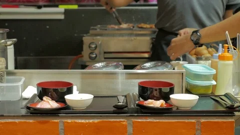 Professional chefs preparing and cooking food in a kitchen. Stock Footage 77652703