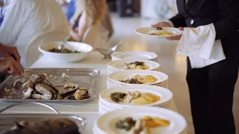 Professional chefs in a restaurant preparing large numbers of food fish with Stock-Footage 94723170
