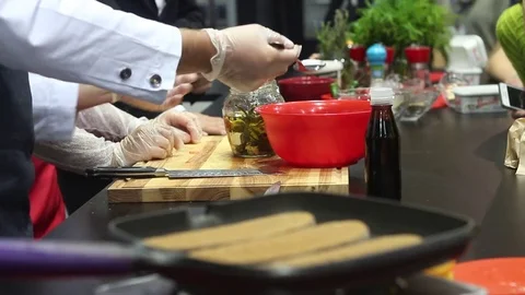 Professional chefs work in a modern kitchen with fresh meat and vegetables. Stock Footage 73425911