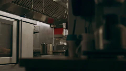 Professional chefs working at their stations at a long counter in industrial kit Video stock 199462858