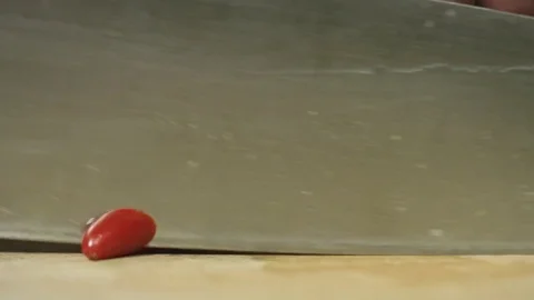 Professional chili pepper cutting, slicing with a chef's knife on cutting board Stock Footage 76955467