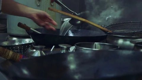 Professional Chinese chef cleans a large wok Stock Footage 78018531