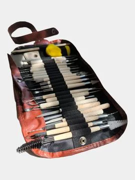 Professional clay sculpting tools set arranged in a leather roll case. Фото