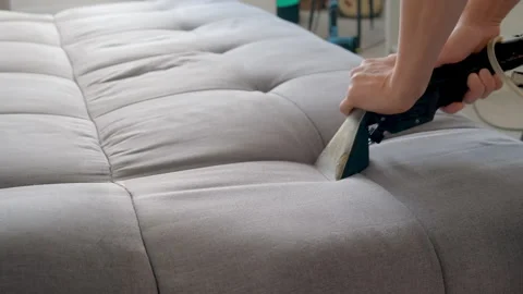 Professional cleaner cleaning use vacuum cleaner to clean dirt stains from sofa. Stock Footage 311799012