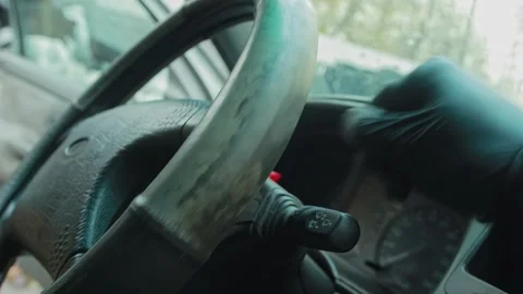 Professional cleaner hand in black glove touches dirty greasy steering wheel Video stock 323911007