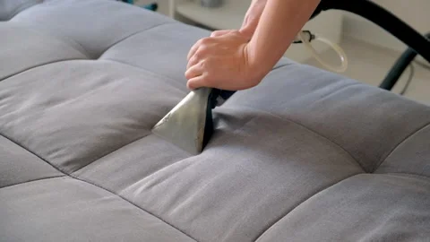 Professional cleaner hands using vacuum cleaner to refresh sofa remove stains. Stock Footage 311799206