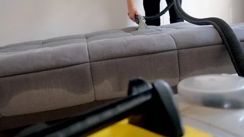Professional cleaner hands using vacuum cleaner to refresh sofa remove stains. Stock Footage 311799535