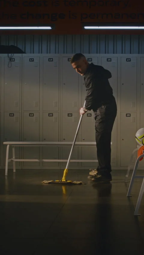 Professional Cleaner Thoroughly Mopping and Disinfecting Sports Dressing Room Stock Footage 339003174