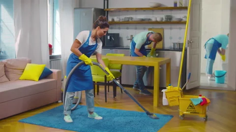 Professional cleaners washing kitchen area during house clean up. Realtime Stock Footage 232575892