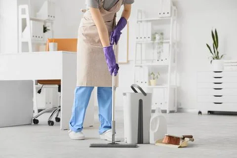 Professional cleaning service worker mopping office floor with modern equipme Stock Photos