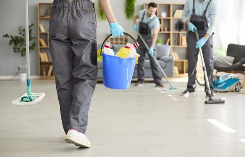 Professional cleaning team sanitizing interior with bucket, gloves, mop, vacuum Stock Photos